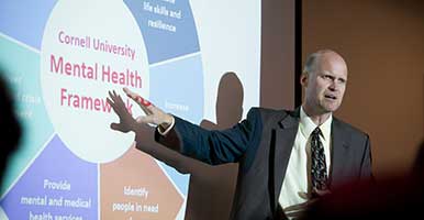 Tim Marchell points to image of Cornell's Mental Health Framework