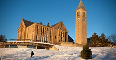 Student near clock tower on the snow-covered Libe Slope
