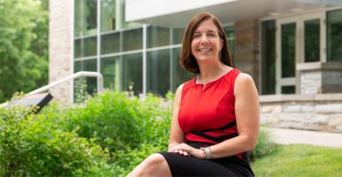 Julie Edwards in front of Cornell Health